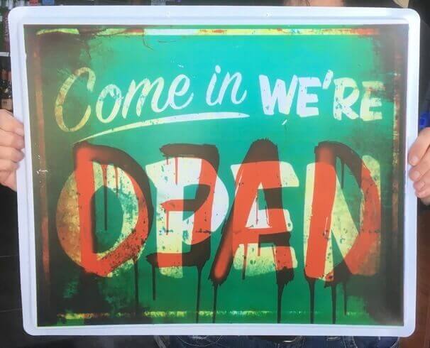 Funny store sign that says "Come In, We're Dead."