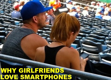 Image of young man and woman at a baseball game. He's watching the game, she's looking at her phone, <b>men dating jokes</b>. Caption: 