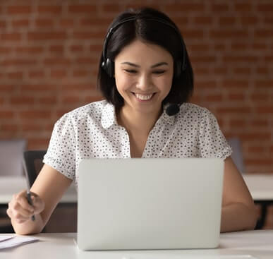 Girl smiling at laptop. Photo of girl smiling at something on her laptop.